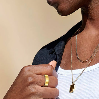 Rivo Ring in Gold worn with a pendant necklace